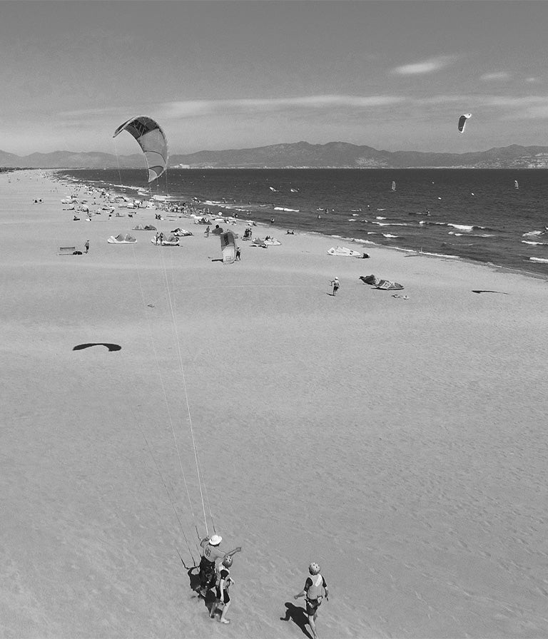 Топ-5 мест для кайтсерфинга с семьей от Mystic 5 Черно-белое изображение с дрона уроков кайтсерфинга в одном из лучших мест для кайтсерфинга в Испании